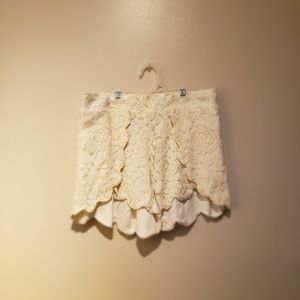 Cream colored crochet type shorts.